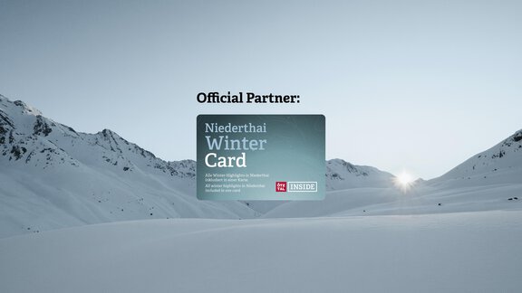 Ein winterliches Bergpanorama mit Schnee und majestätischen Gipfeln. Im Vordergrund ist die Niederthai Winter Card abgebildet. - Sonnenhof - Niederthai