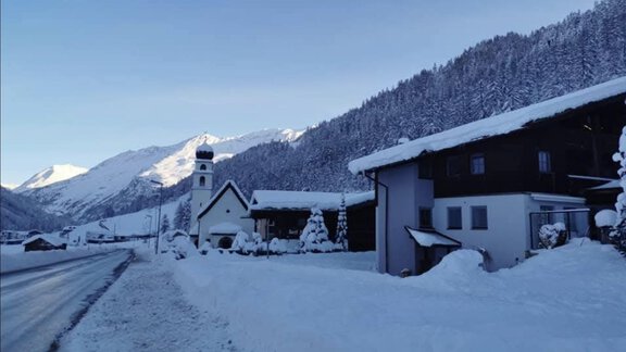 A wintry landscape with snow-covered houses and mountains in the background. The sky is clear and blue, emphasizing the tranquil atmosphere. - Appartementhaus Schalfblick - Obergurgl 