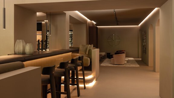 A modern interior with a stylish bar and minimalist design.  
Soft lighting and neutral colors create a relaxing atmosphere. - Austria Gourmet & Wine Hotel - Obergurgl 