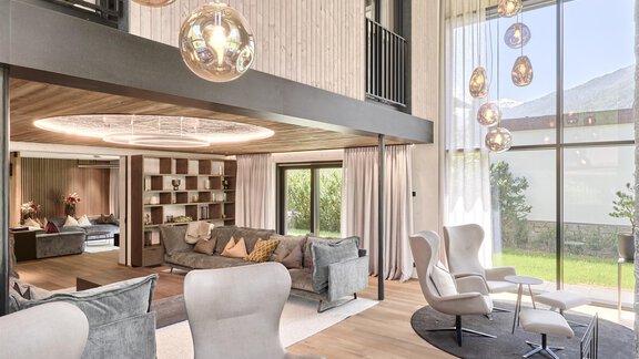A modern living room with elegant furniture and large windows. The stylish lighting and open space create an inviting atmosphere. - Chalet White Pearl by MYALPS - Sölden