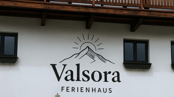 A beautiful holiday home with a wooden porch and an inviting entrance. The house is named "Valsora" and has a modern, friendly facade. - Ferienhaus Valsora - Sölden