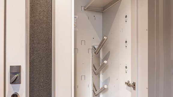 An open storage cabinet with shelves and special holders. The interior view showcases a modern and functional design. - Haus Manfred - Sölden