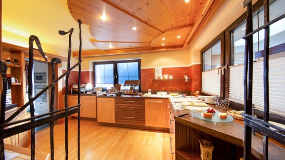 A modern kitchen with wood paneling and plenty of natural light. The space is well-organized and attractively designed. - Haus Stefanie - Sölden