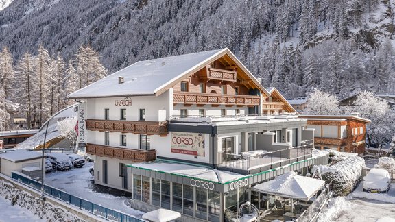 A cozy hotel in the snow with the surrounding mountains. The building has a modern style and creates an inviting atmosphere. - Haus Ulrich - Sölden