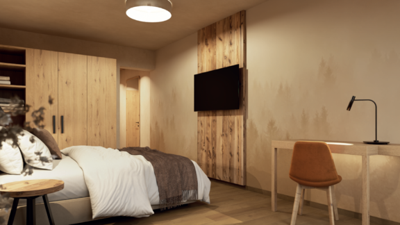 A modern bedroom with wooden shelves and a large bed. A desk and a television complement the cozy atmosphere. - Hotel Garni Hainbacherhof - Sölden