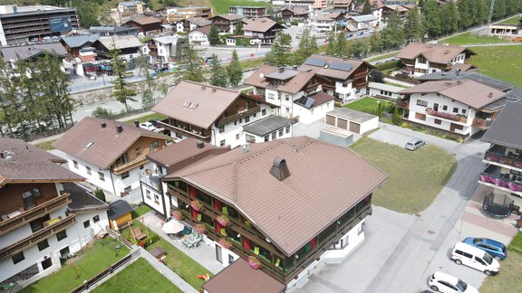 A picturesque village in the mountains with traditional architecture and green meadows. The surroundings showcase a peaceful and charming landscape. - Hotel Garni Maria Theresia - Sölden