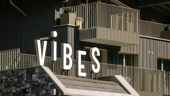 A modern building with a wood design. The lettering "ViBES" is prominently displayed. - VIBES Sölden - your alpine homebase - Sölden