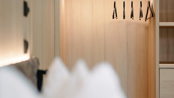 A modern wardrobe made of wood with a bright interior. - VIBES Sölden - your alpine homebase - Sölden