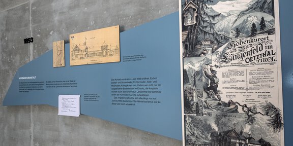 An exhibition with historical images and information about the Wilhelmine Era in a modern space. The walls are designed in various colors and display old drawings as well as a poster. - Thermal-Heilwasser Badl' Längenfeld - Längenfeld