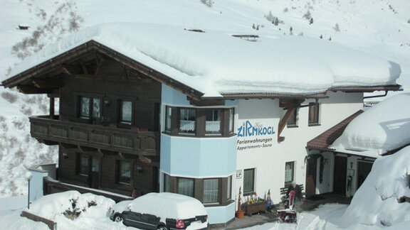 A cozy building in the snow with a traditional chalet roof. There is a lot of snow on the roof and around the house. - Ferienwohnung Zirmkogl - Obergurgl 