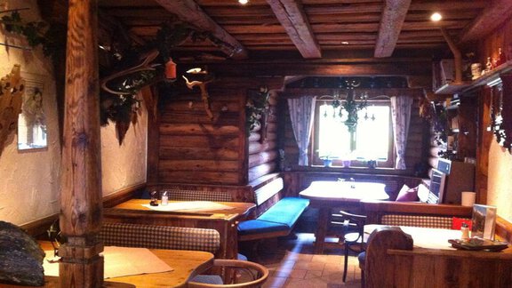 A cozy parlor with wooden paneling and rustic furniture. The atmosphere is warm and inviting. - Erbhof - Sölden