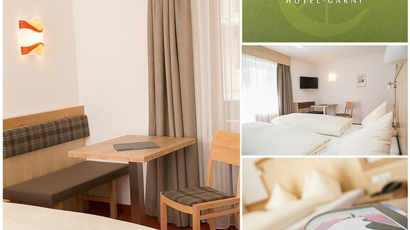 A modern hotel room with a cozy sitting area and a large window. The room is bright and inviting, perfect for relaxed stays. - Hotel Garni Ehrenreich - Sölden