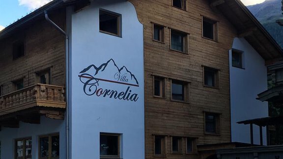 A modern wooden building with the inscription "Villa Cornelia". It has several windows and a charming alpine style. - Sölden