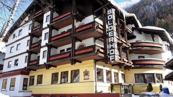 A cozy hotel named "Sölderhof" amidst snow. The architecture combines traditional alpine elements with modern amenities. - Hotel Sölderhof - Sölden