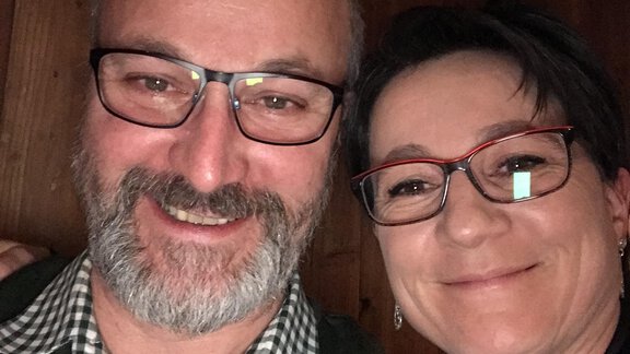 A cheerful selfie of a man and a woman. Both are wearing glasses and smiling at the camera. - Gästehaus Martin - Sölden