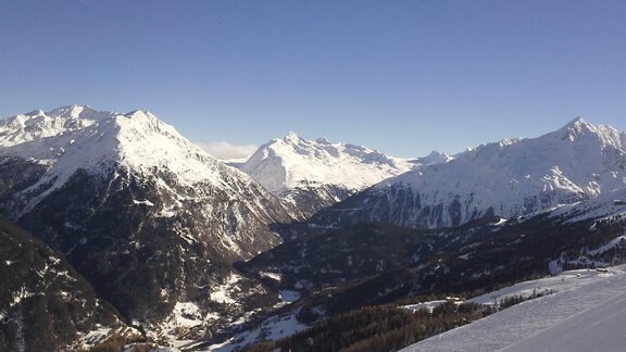 Eine beeindruckende alpine Landschaft mit schneebedeckten Bergen und klarem Himmel. Das Tal darunter ist grün und zeigt eine wunderschöne Natur. - La Luna - Sölden