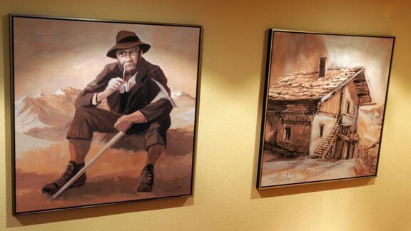 Two artworks on the wall. On the left, there is a miner sitting with a stick, on the right, there is an old house depicted. - Pension Sportalm - Sölden