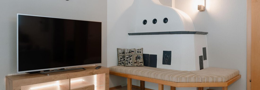 gemütlicher Kachelofen und TV - APART Naturcamping Kuprian - Huben