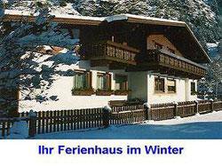 A cozy holiday home in winter, surrounded by snow-covered trees. The facade is traditionally designed with a balcony. - Apartment Ennemoser Sigrid - Längenfeld
