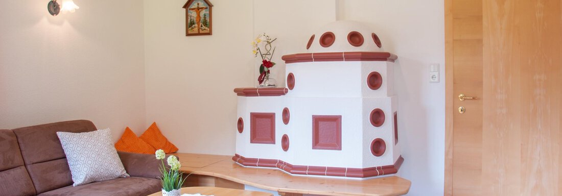 FW Typ B Wohnzimmer Kachelofen Leistungsträger - Haus Lärchenwald App. - Niederthai