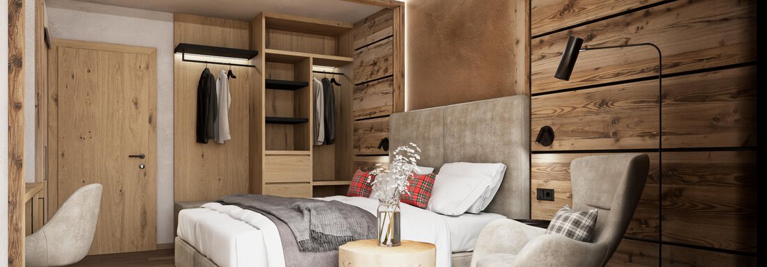 A modern bedroom with wooden walls and comfortably furnished furniture. The warm lighting creates an inviting atmosphere. - Hotel Tauferberg - Niederthai