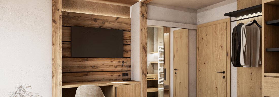 A modern bedroom with wood details and a large bed.  
There is a television and a wardrobe as well as a relaxed atmosphere. - Hotel Tauferberg - Niederthai