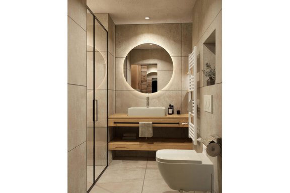 A modern bathroom with clean lines and neutral colors. It features an elegant shower, a sink on a wooden shelf, and a round mirror. - Hotel Tauferberg - Niederthai