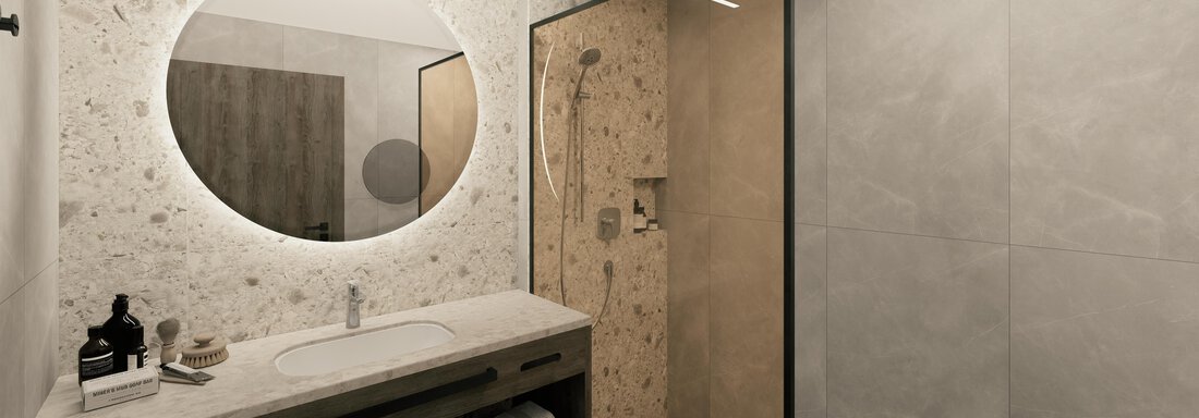 A modern bathroom with an elegant shower and a round mirror. The walls are designed in neutral tones, and there is a minimalist washbasin. - Ferienwohnung de Luxe Alpenresidenz am Mühlbach - Obergurgl 