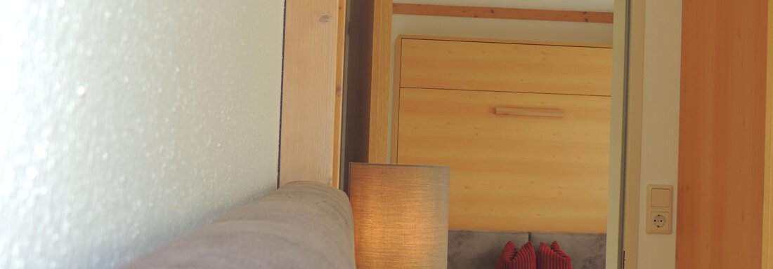 A bright and modern room with a cozy seating area. The room has a warm wood look and a comfortable atmosphere. - Haus Christophorus - Obergurgl 