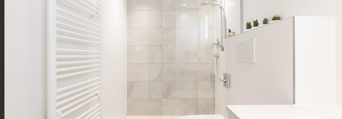A modern bathroom with bright tiles and a shower area. The decor is designed to be simple and functional. - Haus Verwall Appartements - Obergurgl 