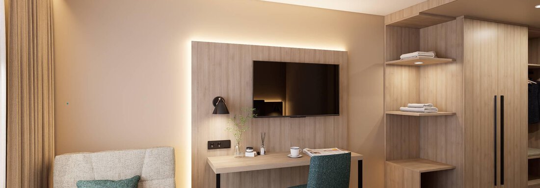 Ein modernes Hotelzimmer mit einem gemütlichen Bett, einem Schreibtisch und einem Fernseher. Die Wände sind in sanften Farben gehalten und es gibt viel Platz für persönliche Gegenstände. - Hotel Marko - Oetz