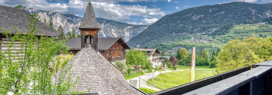 A picturesque mountain village with traditional houses and an impressive mountain landscape in the background. The sky is clear with some clouds. - Seehüter´s Hotel Seerose - Oetz