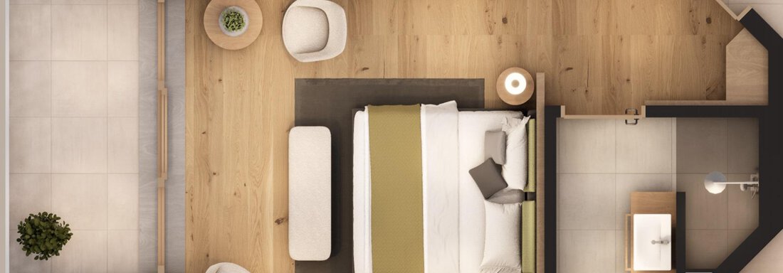 A modern room with a large bed, a chair, and a table. The floor is made of light wood and there are some decorative plants. - A CASA "Aventurin" - Sölden