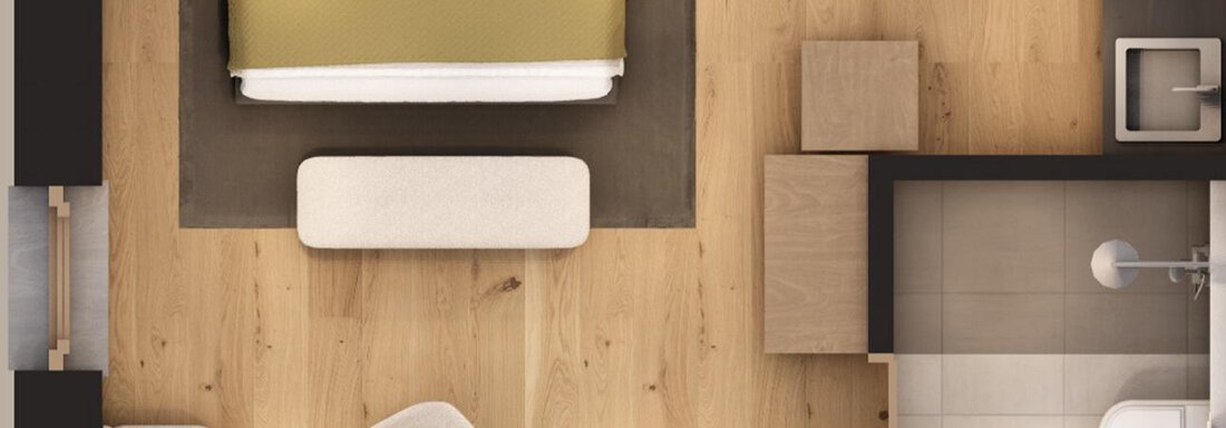 A modern bedroom with a large bed and bright wooden floors. There is also a cozy seating area and a separate bathroom. - A CASA "Aventurin" - Sölden