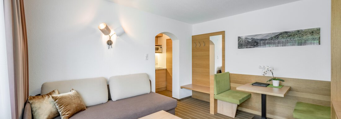 230620_092349 A modern living room with a comfortable sofa and a wooden table. The soft colors and the table group create an inviting atmosphere. - Apart Hotel Garni Wieser - Sölden
