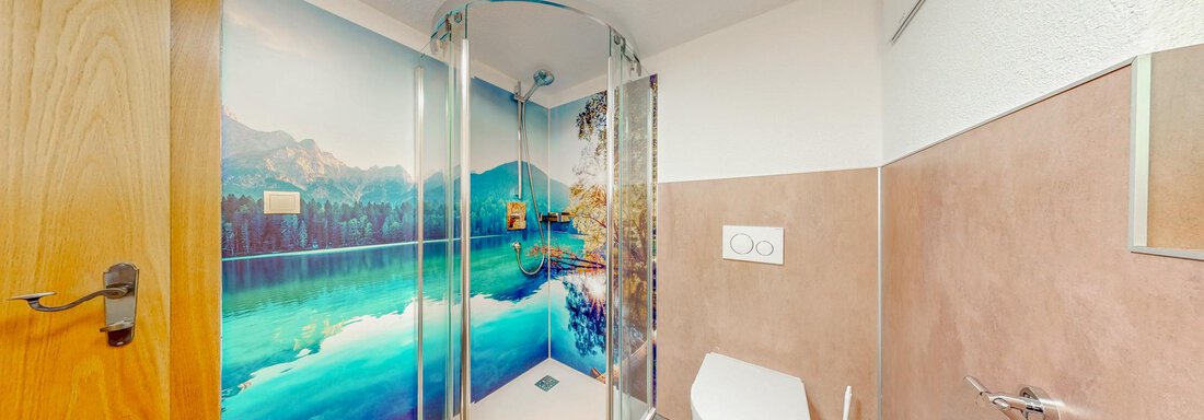 A modern bathroom with a shower cabin and a beautiful wall painting of a landscape. The furnishings are simple and functional, with warm colors. - Belmonte Sölden - Sölden