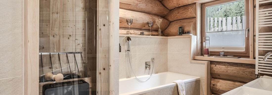 An elegant bathroom with wooden walls and a modern design. It features a bathtub and a shower, as well as a window overlooking the outdoors. - Chalet Resort Sölden - Sölden