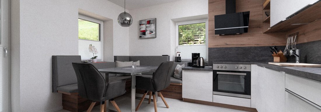 A modern kitchen with bright walls and a wooden table. The room is well-lit and has stylish furniture. - Ferienhaus F2 - Sölden - Sölden