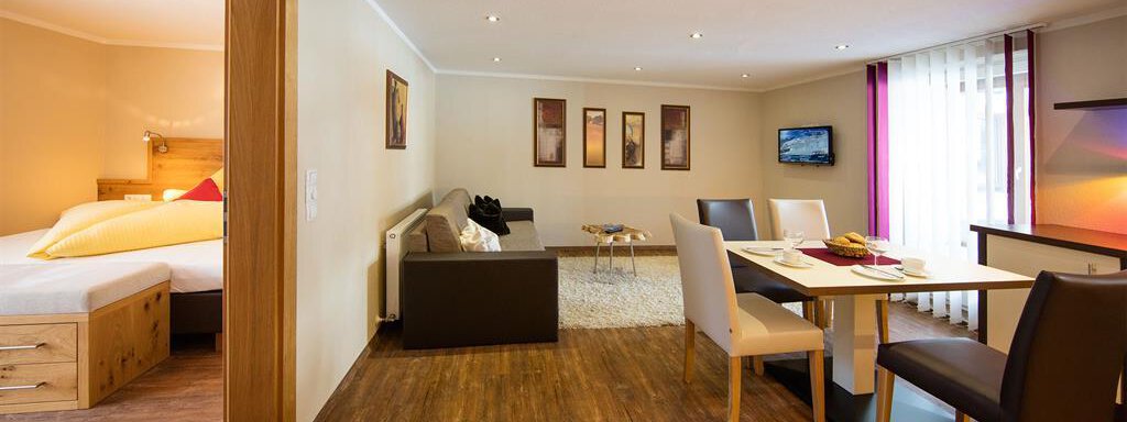 A spacious, modern apartment with a cozy living area and dining space. Bright colors and plenty of daylight create an inviting atmosphere. - Haus Stefanie - Sölden