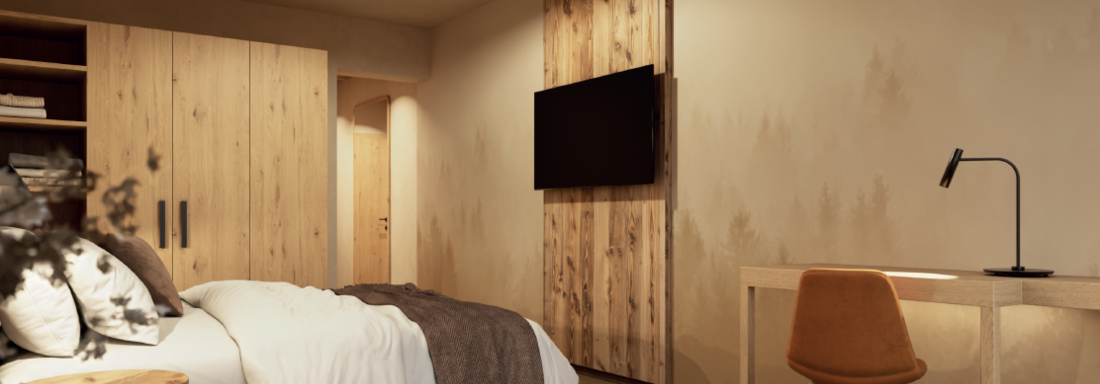 A stylish bedroom with a cozy bed and a wooden dresser. On the wall, there is a television and a desk with an orange chair. - Hotel Garni Hainbacherhof - Sölden