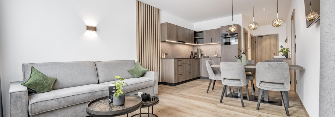 Modern apartment with a cozy seating area and a dining space. Bright colors and elegant furniture create an inviting atmosphere. - Marco's Mountain Home - Sölden