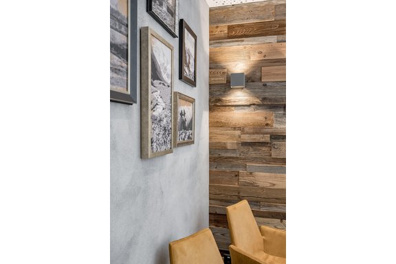 A cozy corner with bright wood paneling and pictures on the wall. Two comfortable mustard-yellow chairs complement the modern ambiance. - Residenz Allegra - Sölden