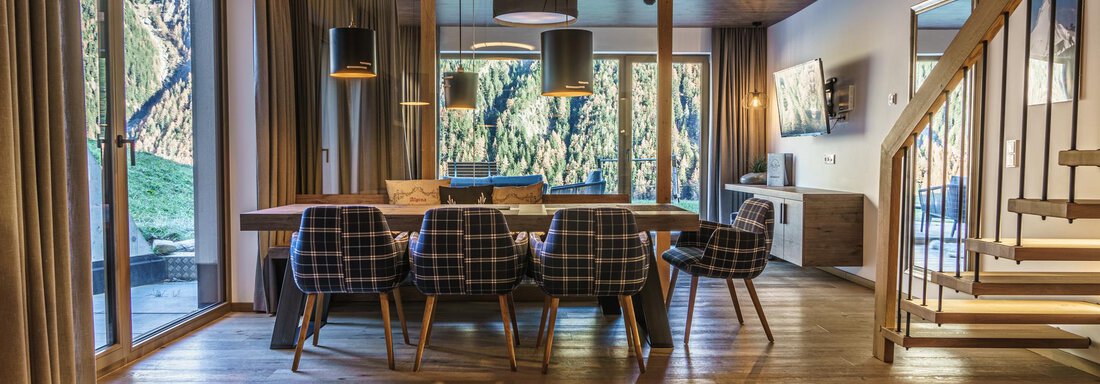 DSC03416-HDR A modern dining room with a large wooden table and stylish chairs. Large windows offer a view of nature outside. - The Peak Sölden - Sölden