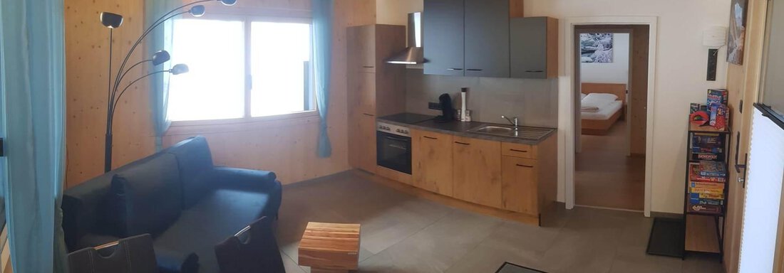 A modern, bright apartment with a cozy living room and a kitchen. The furnishings are made of wood and offer a view outside. - Haus Fortuna - Zwieselstein